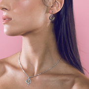 Sterling silver earrings with a peridot circle and bar, another view